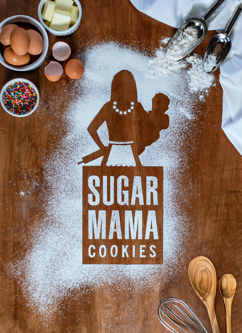 product brand photography of Sugar Mama Cookies logo stencil with flour and baking ingredients