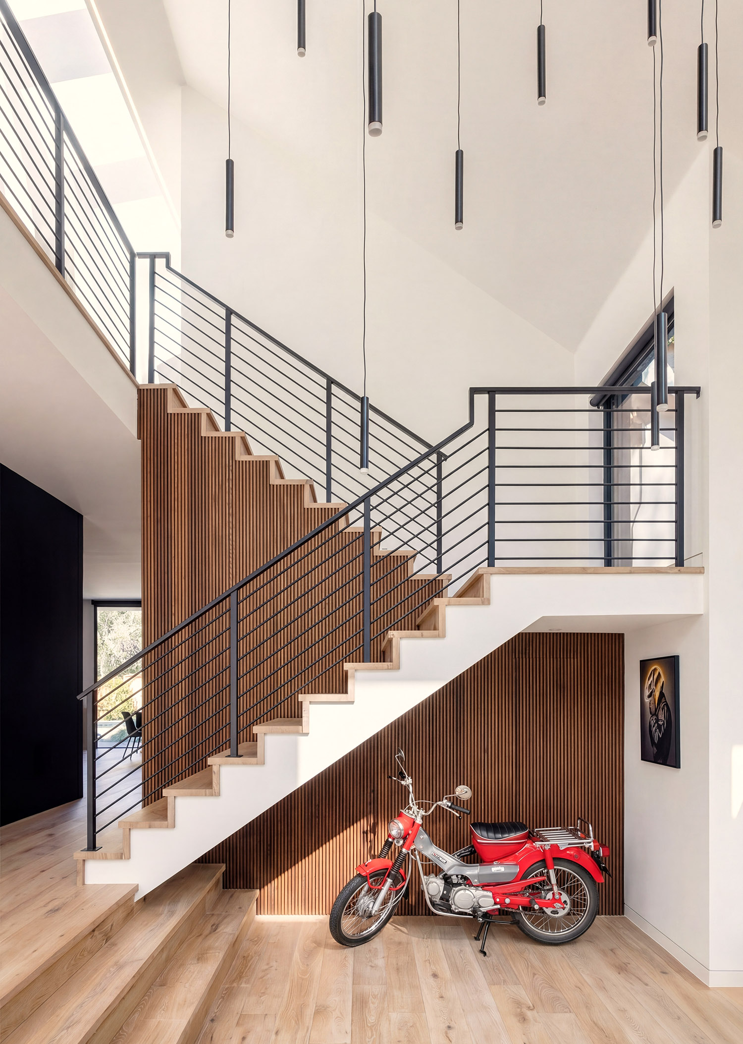 Living room stairwell with motorcycle display