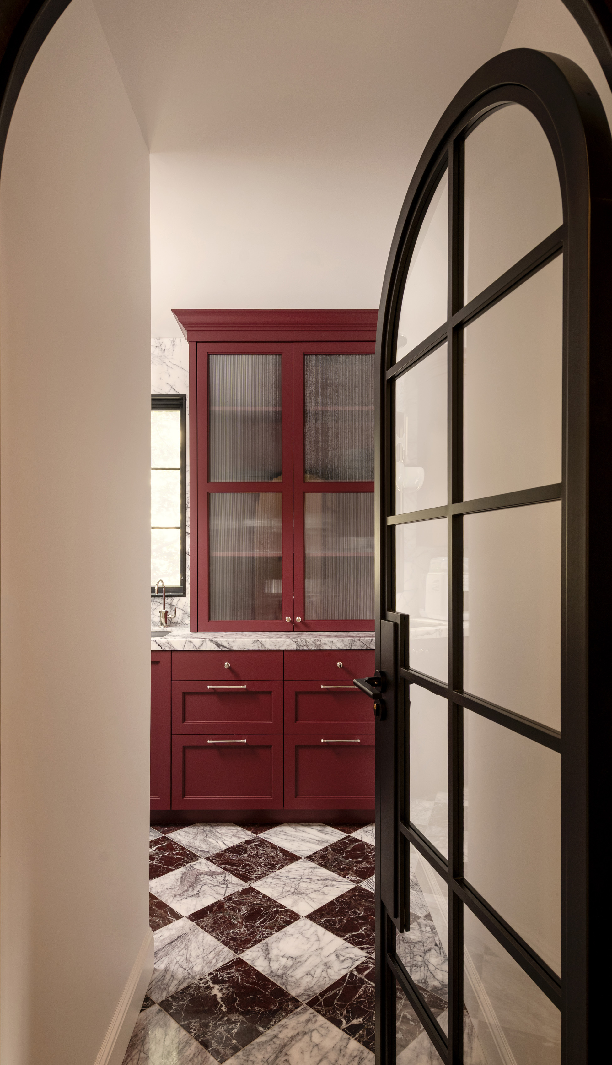 Arched hallway with custom doorway to the kitchenette