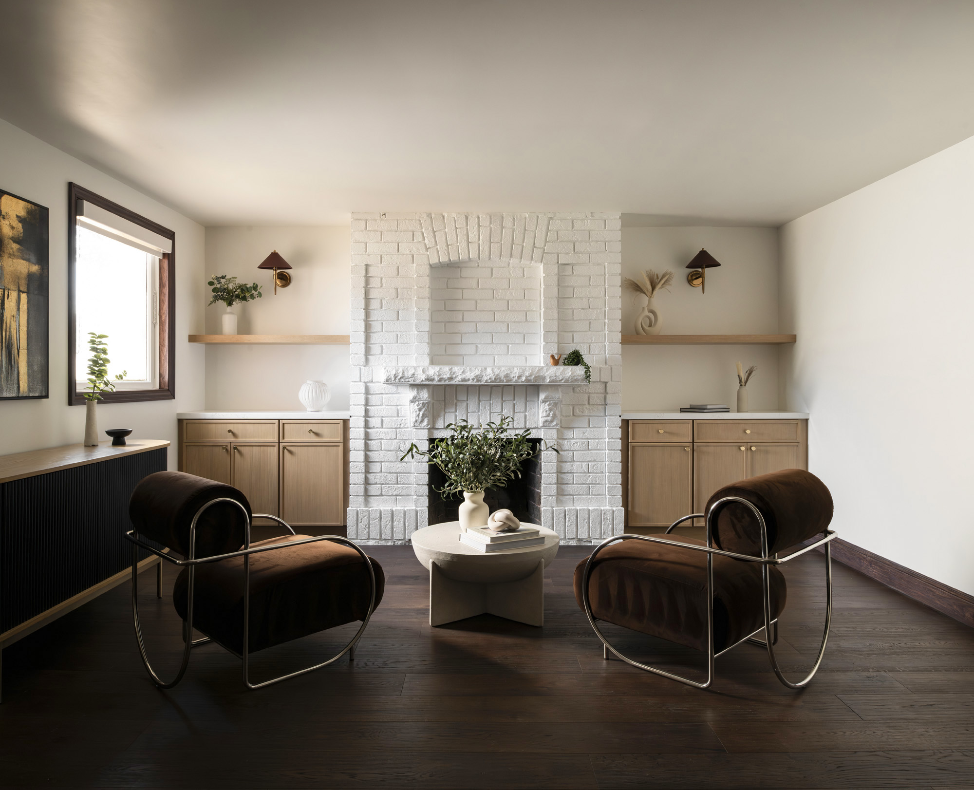 A family room with fireplace, updated with modern cabinetry and floors for a contemporary style - interior design photography by Philippe Newman