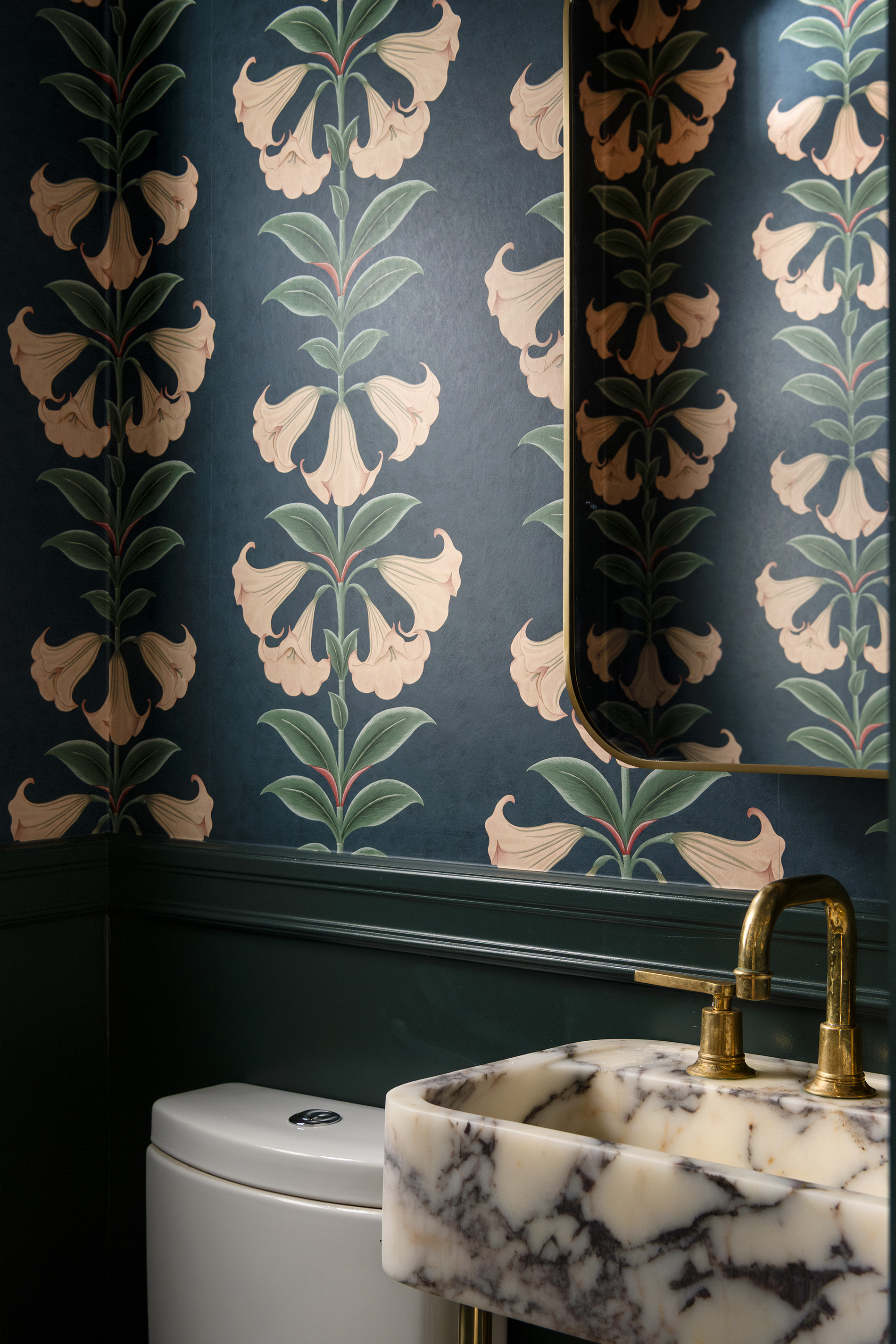 contemporay powder room with floral design walls, marble vanity and patina brass faucet - interior design photography by Philippe Newman