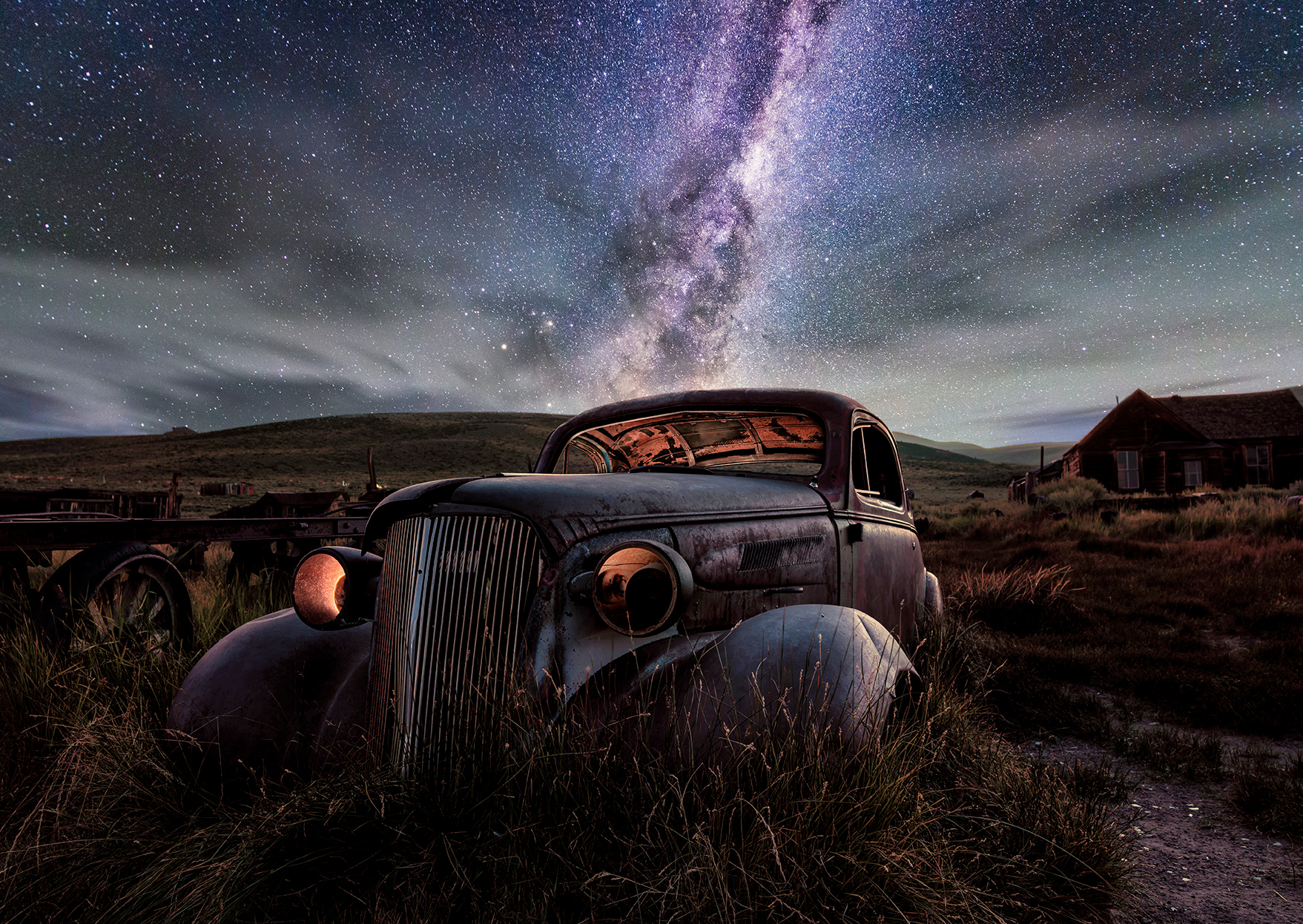 night starscape photography of an old abandoned Chevy in the hills near Mono Lake, California