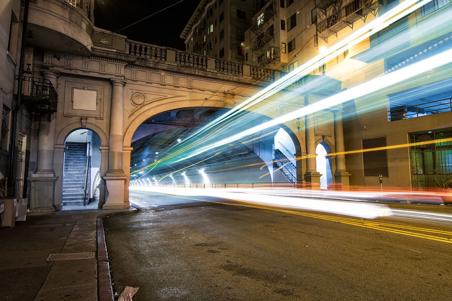 car light trails blast out of the SF Stockton street tunnel at night - San Francisco street photography